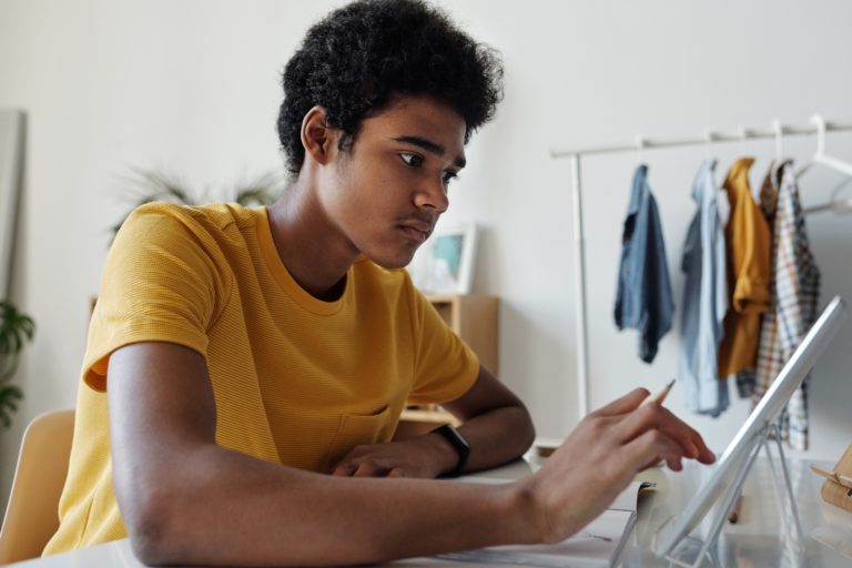 A young man uses a tablet